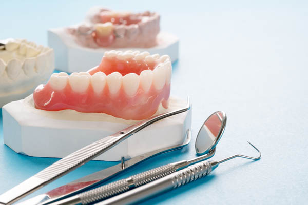 Adjusting To New Dentures: Can You Brush Your Dentures Like Regular Teeth?